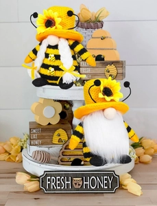 Detail of bee theme tiered tray decor with plush gnomes and honey wooden signs