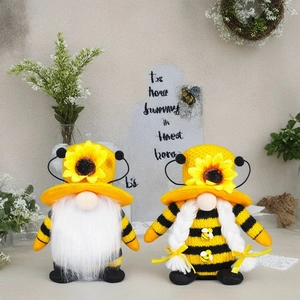 Detail view of bee-themed gnome plush toys with sunflower hats and striped bodies