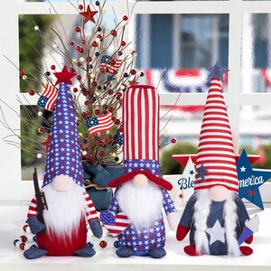 Three USA Independence Day patriotic gnomes with American flag patterns on a window sill