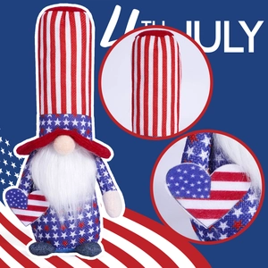 Detail of a Fourth of July gnome showing a striped hat and a heart-shaped American flag