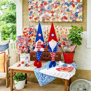 Close-up of patriotic long-legged gnomes sitting on a vintage suitcase for Independence Day