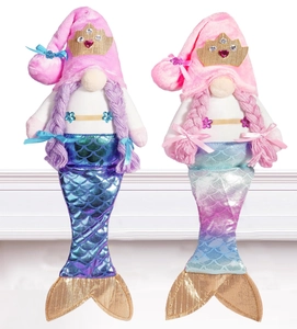 Detail of mermaid gnome plush dolls with sequined fish tails and golden crowns