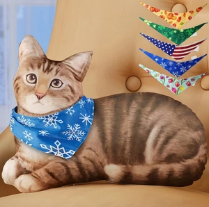 3D cat pillow with interchangeable seasonal scarves featuring various holiday patterns