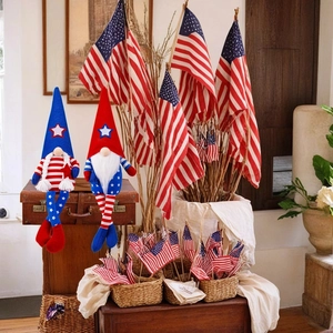 Close-up of patriotic gnome dolls with American flag patterns on a vintage suitcase