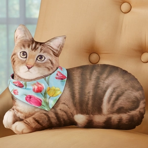 Realistic tabby cat throw pillow with blue floral scarf on a modern lounge chair