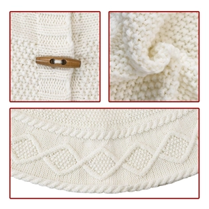 Detail of ivory knit Christmas tree skirt with cable patterns and wooden toggle button