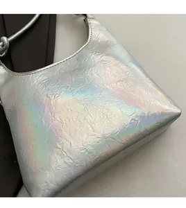 Detail of holographic silver shoulder bag showing its unique wrinkled texture and metallic sheen