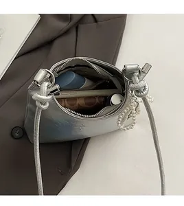 Internal view of silver bucket bag showing large capacity for phone and cosmetics