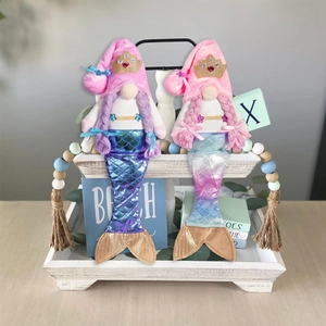 Pair of summer mermaid gnomes with sparkling fishtails and crowns on wooden tray