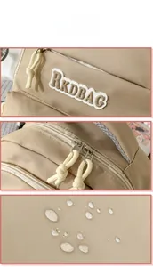 Detail view of waterproof khaki backpack fabric with RKDBAG logo and two-way zippers