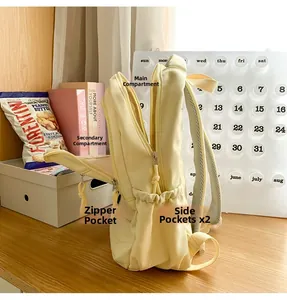Detailed interior storage view of cream school backpack with multi-pocket layout