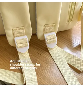Adjustable padded straps on the light yellow backpack for various heights and comfort