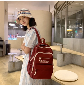 Deep red large capacity backpack featuring RKDBAG embroidery and cream zipper piping
