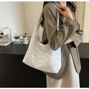 White large-capacity tote bag with wave stitching texture shown on a female model