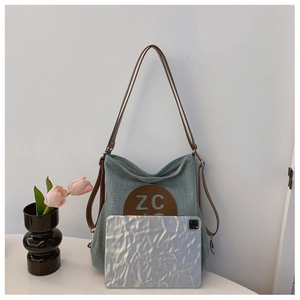 Detailed shot showing spacious canvas tote bag fitting a silver tablet and brown straps