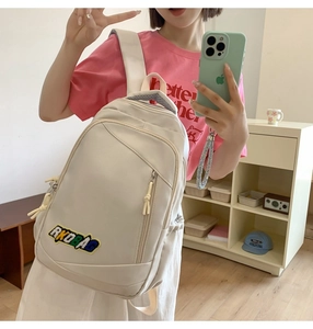 Close-up of beige waterproof nylon backpack with RKOBAG patch and front zipper pocket
