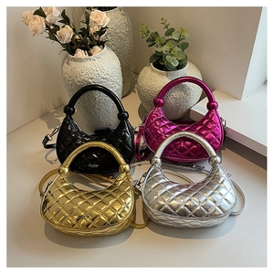 Group of metallic quilted handbags in black, gold, silver, and rose red with top handles