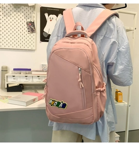 Pink waterproof nylon backpack with RKOBAG patch showing large capacity storage
