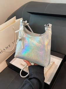 Holographic silver bucket bag with pleated texture and pearl bow charm in a gift box
