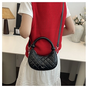 Quilted black leather dumpling bag with fixed top handle and crossbody strap