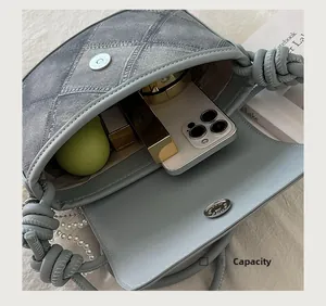 Close-up of light blue denim crossbody bag interior showing spacious storage capacity