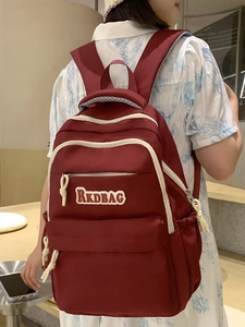 Student backpack in burgundy canvas with RKDBAG patch and multi-pocket design