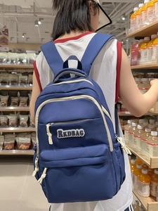 Large capacity navy blue backpack with white zipper detail for school and travel
