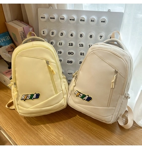 Detailed close-up of nylon backpacks with RKDBAG embroidery and multi-pocket design