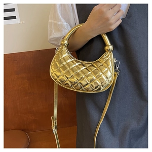 Detail of golden quilted hobo bag featuring metallic texture and Fashion BAG logo