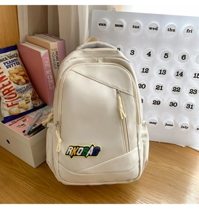 Detail of off-white backpack featuring RKDBAG embroidery and multiple storage pockets