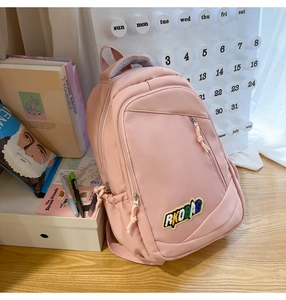 Detailed view of pink school backpack with RKDPAG embroidery and checkered handle