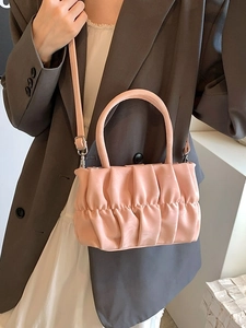 Pale pink pleated cloud bag with round handle for shoulder and crossbody wear