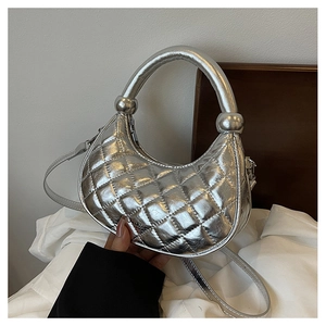 Detailed close-up of the silver quilted leather texture and metallic semi-circle design
