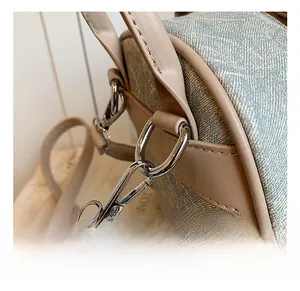 Gros plan du crochet en métal argenté et du tissu tissé bleu-gris d'un sac à dos