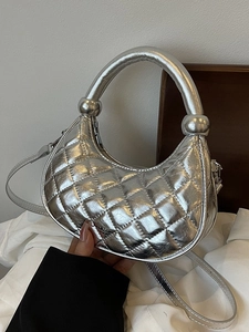 Chic silver metallic quilted half-moon handbag with top handle and crossbody strap