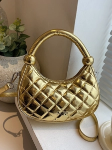 Metallic gold quilted dumpling handbag with top handle and crossbody strap for women