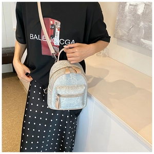 Detail of mini backpack with textured light gray fabric and adjustable shoulder straps