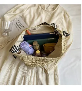 Top view of a straw tote bag interior showing large capacity and magnetic metal clasp