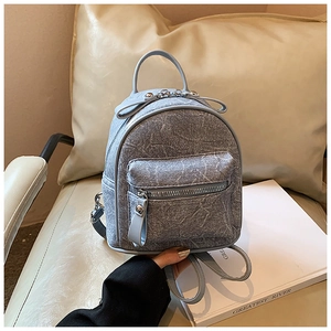 Close-up of light blue mini backpack with marble texture and silver hardware