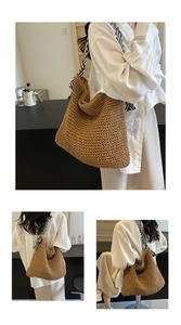 Detail showing the brown hand-woven straw tote bag with black and white striped strap