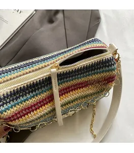 Detail shot of smooth white zipper closure on a colorful woven cylindrical bucket bag