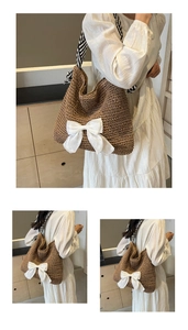 Detail of large straw tote bag featuring a prominent white bow and striped strap