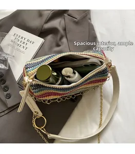 Detail of colorful woven crossbody bag showing spacious interior with cosmetics and chain strap