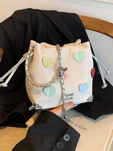 White woven bucket bag with macaron heart charms and a silver chain strap for women