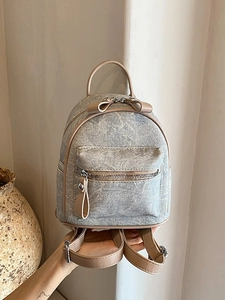 Mini light blue textured backpack with beige leather trim and main zipper pocket for women