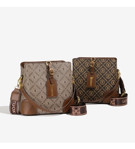 Detail view of printed bucket bags with wide jacquard straps in brown and tan tones