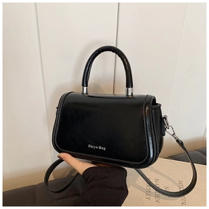 Détail du petit sac noir en cuir avec boucles argentées et logo Shiyu-Bag distinctif