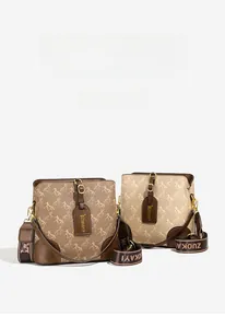 Detail of trendy bucket bags with horse print and detachable wide fabric shoulder straps