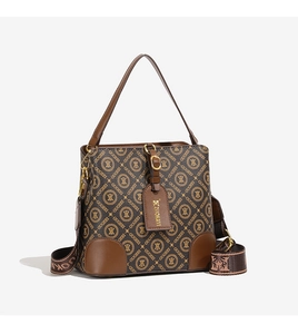 Detailed view of dark brown bucket bag with monogram pattern and wide adjustable strap