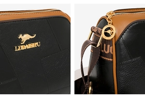 Nahaufnahme des goldenen Känguru-Logos und Lederstruktur der Boston-Tasche